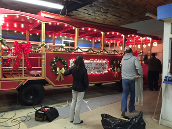 Bank of Washington employees decorate red trolley for Holiday parade with lights and wreaths