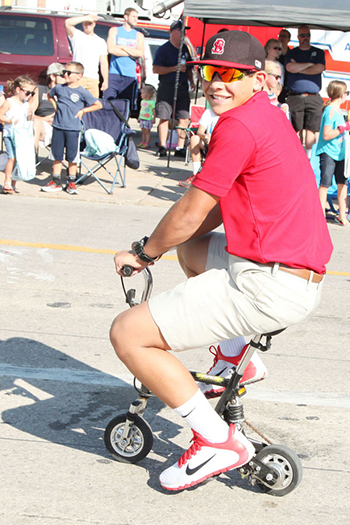 Boy riding mini bike in Fair parade