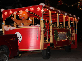 Trolley decorated for Christmas with Gingerbread Man on it in parade