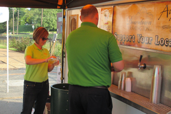 Bank of Washington employees serving beer at Sunset on the Riverfront