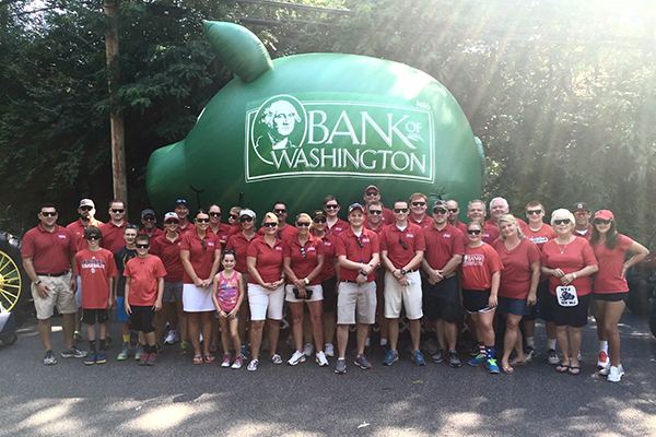 Bank of Washington employees in front of big, inflatable pig for the Washington Town & Country Fair Parade