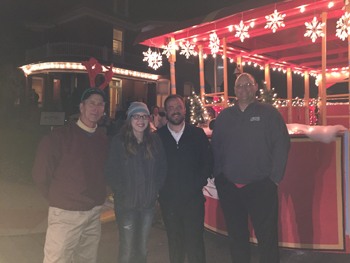Bank of Washington employees standing in front of red trolley before Holiday parade