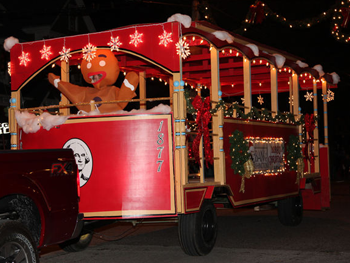 Trolley decorated for Christmas with Gingerbread Man on it in parade