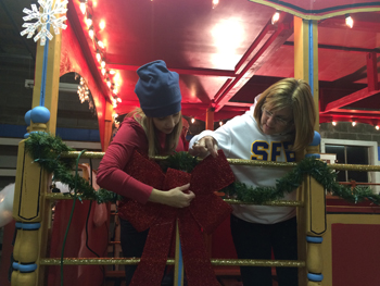 Bank of Washington employees adding bows the red trolley for holiday parade