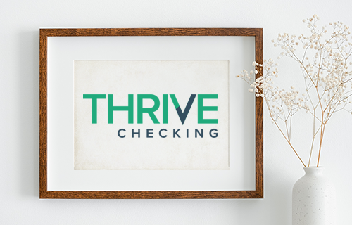 Thrive Checking logo in frame on white wall