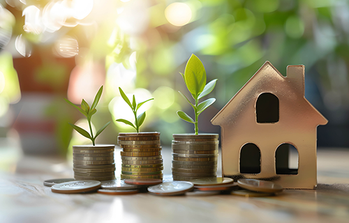 coins with plant stems growing out of them sitting beside a house decoration piece