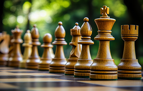 tan chess board on green, blurred background