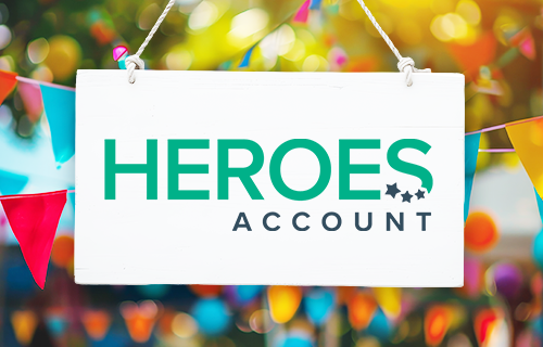 green and navy Heroes Account logo on white sign with colorful banners in background