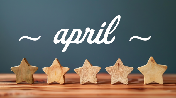 April written above the five wooden stars in front of navy background