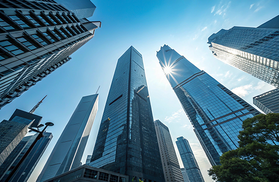 city buildings with the sun reflecting off of them