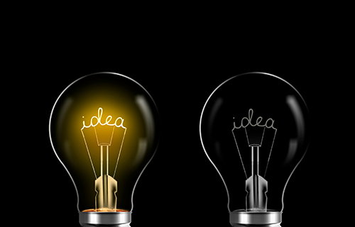 two lightbulbs on black background with the word "idea" in both of them with one lightbulb shining bright